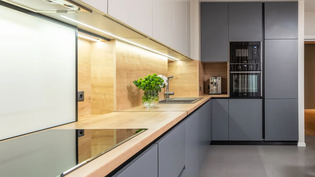 Cocina moderna en gris con horno y microondas integrados en columna y placa de inducción